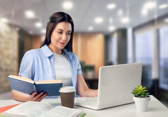 Fototapeta premium Joyful happy freelance worker works at laptop in office