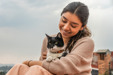 Woman caressing adorable stray cat