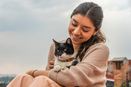 Woman caressing adorable stray cat