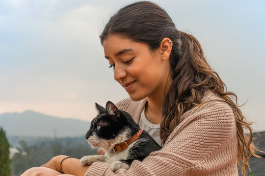 Woman caressing adorable stray cat