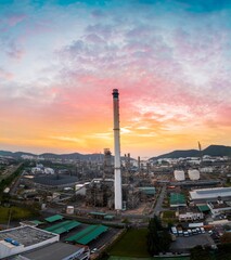 Crude Oil Refinery Plant Steel Pipe line and Chimney and Cooling tower, Chemical or Petrochemical factory plant power plant, Petrochemical tower tank industry at sunset