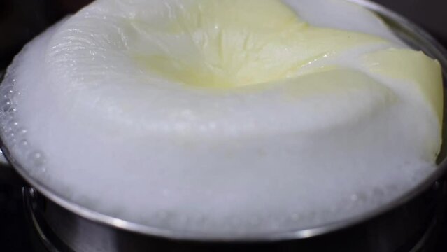 Boiling of milk in a vessel. A symbol of auspiciousness in dedication of houses, house warming, cooking, healthy and baby food. Milk processing for pasteurization.