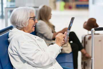 Happy senior woman using tablet