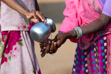 Indian Rural Woman Cleaning Hand in Desi Style - obrazy, fototapety, plakaty