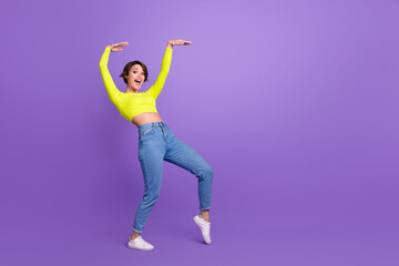 Fototapeta na wymiar Full body photo of positive nice lady chilling dancing rejoice empty space advert isolated on violet color background