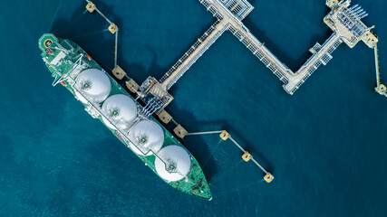 LNG (Liquified Natural Gas) tanker anchored in Gas terminal gas tanks for storage. Oil Crude Gas Tanker Ship. LPG at Tanker Bay Petroleum Chemical or Methane freighter export import transportation  - obrazy, fototapety, plakaty