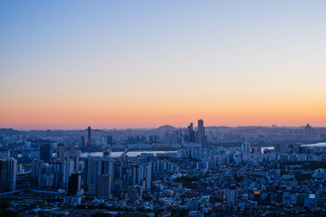 Inwangsan mountain, Seoul City view looking at seoul tower at sunrise in South Korea.