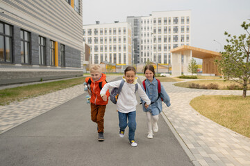 Cheerful children running on street