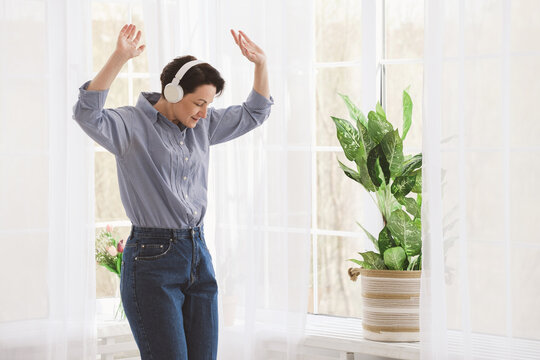 Woman listening to music in living room