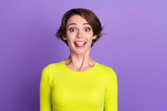 Portrait photo of funky girl joking laughing positive teasing stick out tongue fooling humorous comic isolated on violet color background