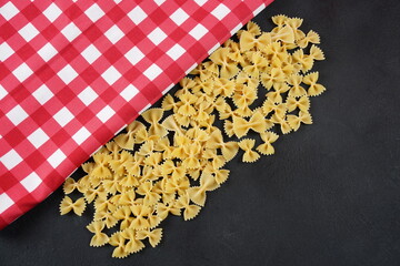 Dried Italian pasta - Farfalle on a table. Raw food background