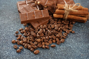 Chocolate and coffee beans on a table. Spices, cinnamon.