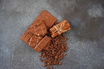 Chocolate and coffee beans on a table. Spices, cinnamon.