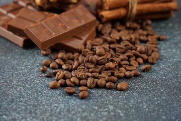 Chocolate and coffee beans on a table. Spices, cinnamon.