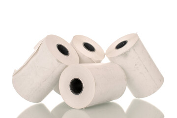 Four rolls of paper cash register tape, close-up isolated on white background.