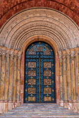 Fototapeta premium Decoration on the closed side door of a cathedral near downtown Cuenca, Ecuador (Cathedral of the Immaculate Conception.)