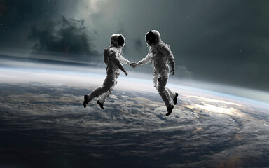 Astronauts couple in deep space. 5K realistic science fiction art. Elements of image provided by Nasa © Vadimsadovski