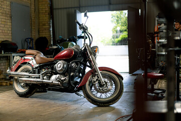 Fototapeta na wymiar authentic motorcycle workshop a beautiful modern motorcycle stands in the garage before repair