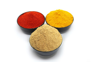 Indian Colourful Spices in black bowl Red Chilli Powder, Turmeric Powder, Coriander Powder, Mirchi, Mirch, Haldi, Dhaniya Powder Isolated on White Background ( top view)