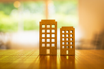 Wooden house, business building model on wood background, a symbol for construction , ecology, loan, mortgage, property or home.