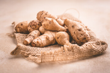 Fresh organic topinambur on wooden background