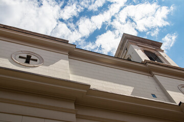 White architectural cornice and roofline beneath clouds in Italy © Miros