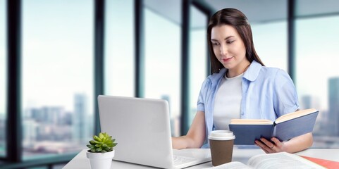Joyful happy freelance worker works at laptop in office