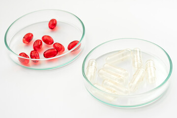 Red Pills and Empty Placebo Capsules in Glass Petri Dish Concept for Placebo-controlled Trials in Healthcare, Laboratory Medicine Analysis and Testing Medication Benefits