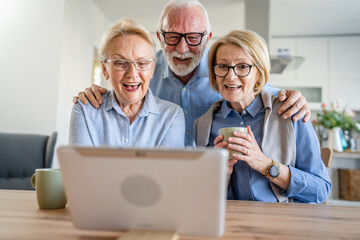 senior mature family or friends use digital tablet online video call