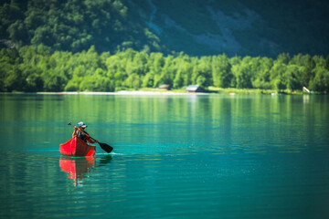 Man in a Canoe Crossing Glacial Lake in the Norway