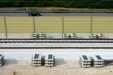 Laying of new railroad tracks. Steel construction materials and sleepers. ICE high-speed rail line....