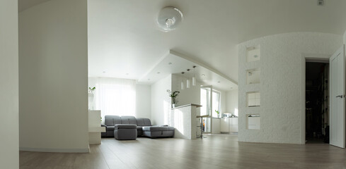 contemporary living room with open concept view through to dining room kitchen and a marble fireplace with gas fire