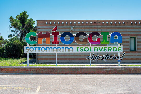 Multicolored sign welcoming tourists to the beaches of Sottomarina near Venice, with the words: Chioggia, Sottomarina, Isolaverde, what a history!