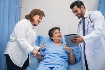 Yong male doctor consulting senior man at hospital. Medical staff explaining diagnosis to patient. Medicine and healthcare concept.