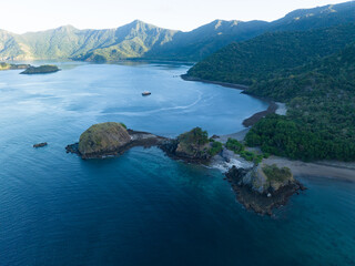 A bird's eye view shows Cannibal Rock, a world class dive site in Horseshoe Bay, Komodo National Park, Indonesia. This beautiful area is home to incredible marine biodiversity.