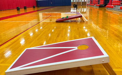 Cornhole game boards and bowling set up in a gym © coachwood