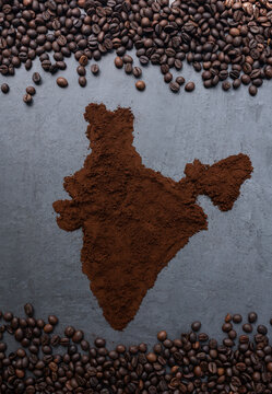 Indian Coffee concept background coffee beans with coffee powder in shape India Map