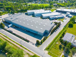 Foto op Plexiglas Aerial view of distribution center, drone photo of industrial logistics zone,new super modern logistics center full of modern technology and robotics,roof solar power plant for green energy production © netsay