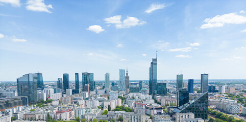 Aerial panorama of Warsaw, Poland over the Vistual river and City center in a distance. Downtown skyscrapers cityscape. Business - obrazy, fototapety, plakaty