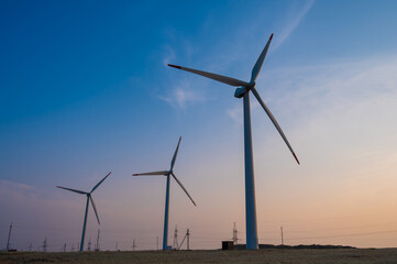 Windmills at sunset. Alternative energy source.