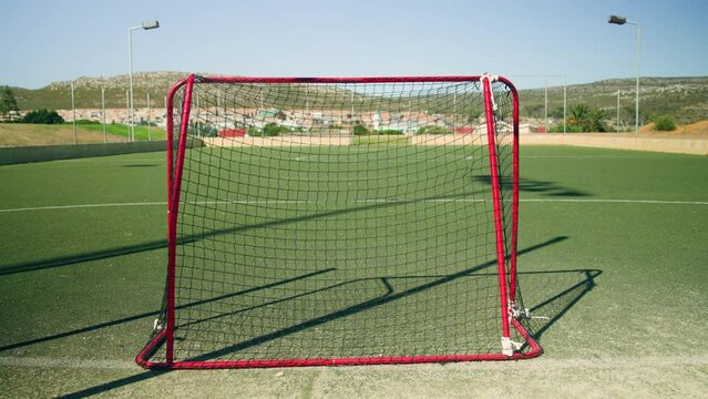 A floorball goal on a green sports field outdoors