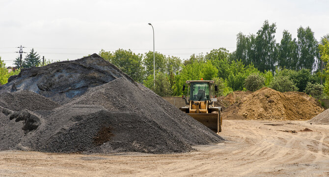 Poland Ostrowiec Swietokrzyski May 25, 2023 at 12:51. Liebherr wheel loader. A Liebherr wheel loader standing next to a heap of - used as road base material. 