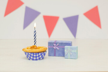 Two birthday gift box with cupcake on wood background