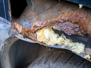 Using polyurethane foam to fill the voids of a rusty car fender