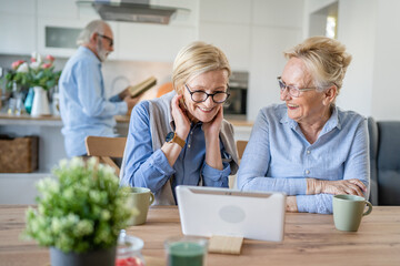 senior mature women family or friends use digital tablet video call