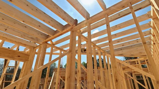 Under construction new house requires installation wooden beams as inside frame support