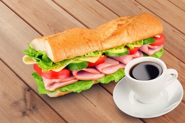 Fresh tasty sandwich with salad on desk