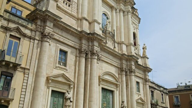 The Metropolitan Cathedral of Saint Agatha in the old town of Catania, Sicily. Prominent baroque cathedral with columned facade, domed roof, frescoes, and stunning paintings in Italy.