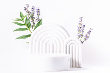 Beautiful composition with white geometric podiums for cosmetic exhibition and fresh aromatic lavender flowers on white background close up, copy space for your design. © Iryna