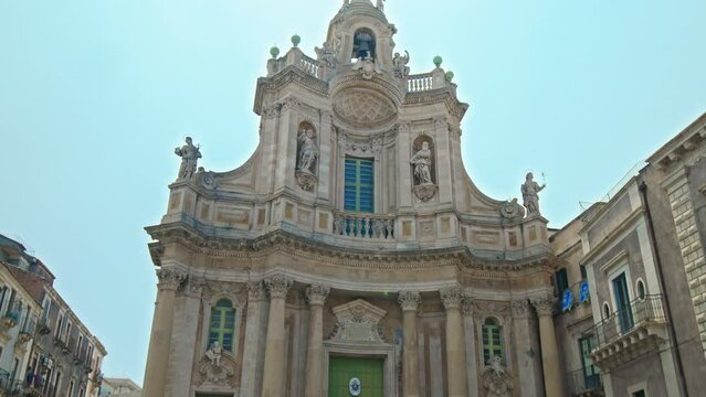 Close-up view of Basilica della Collegiata in Catania, Italy. Historical church featuring a baroque-style facade and a domed, vaulted ceiling with painted frescos in Sicily.